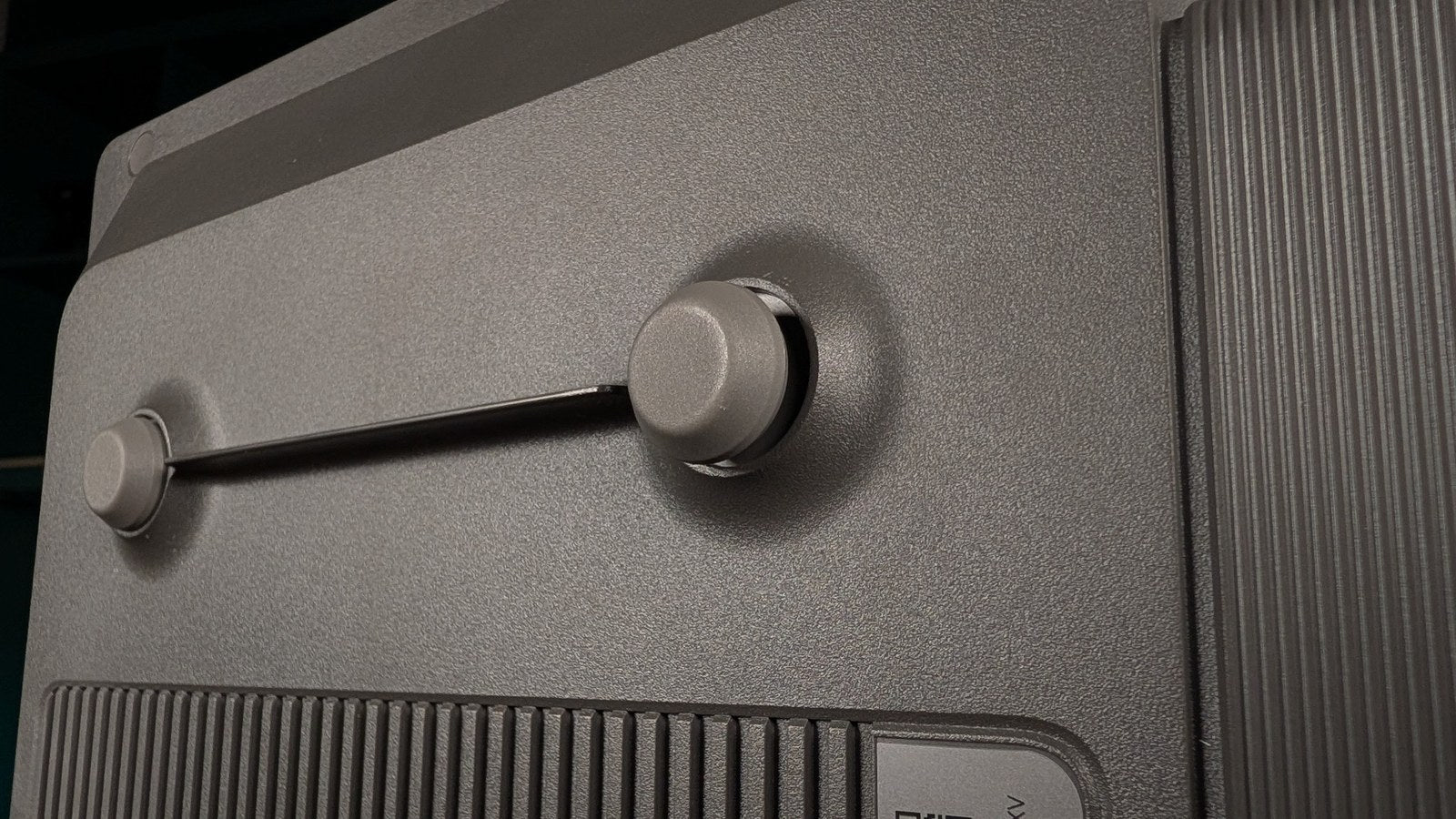 Close-up of one pair of adjustable feet on the bottom of the XGIMI Aura 3 Max