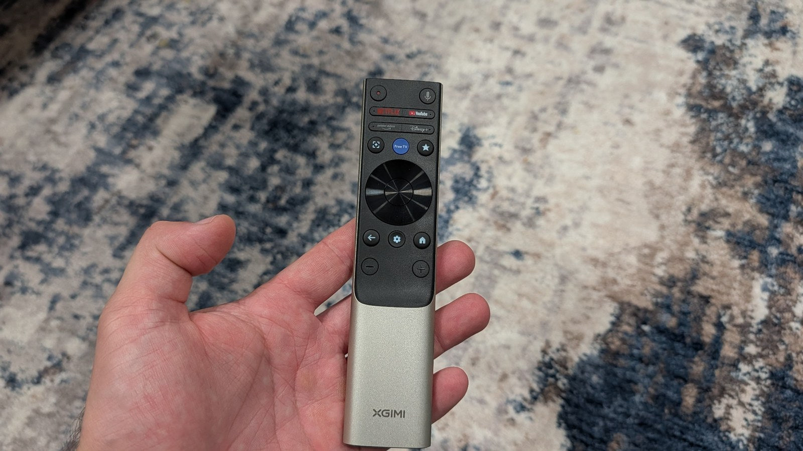 XGIMI Aura 3 Max remote control held in hand