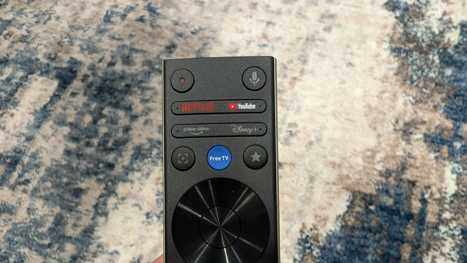 Upper half of the XGIMI Aura 3 Max remote showing microphone and streaming shortcut buttons
