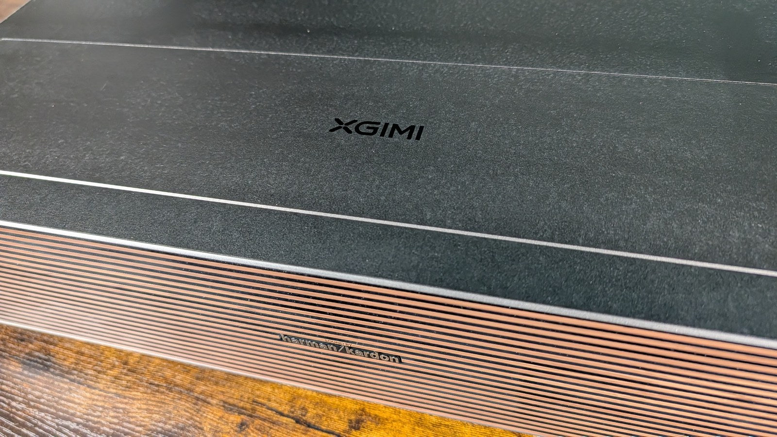 Top of the XGIMI Aura 3 Max showing the XGIMI-branded protective lens cover
